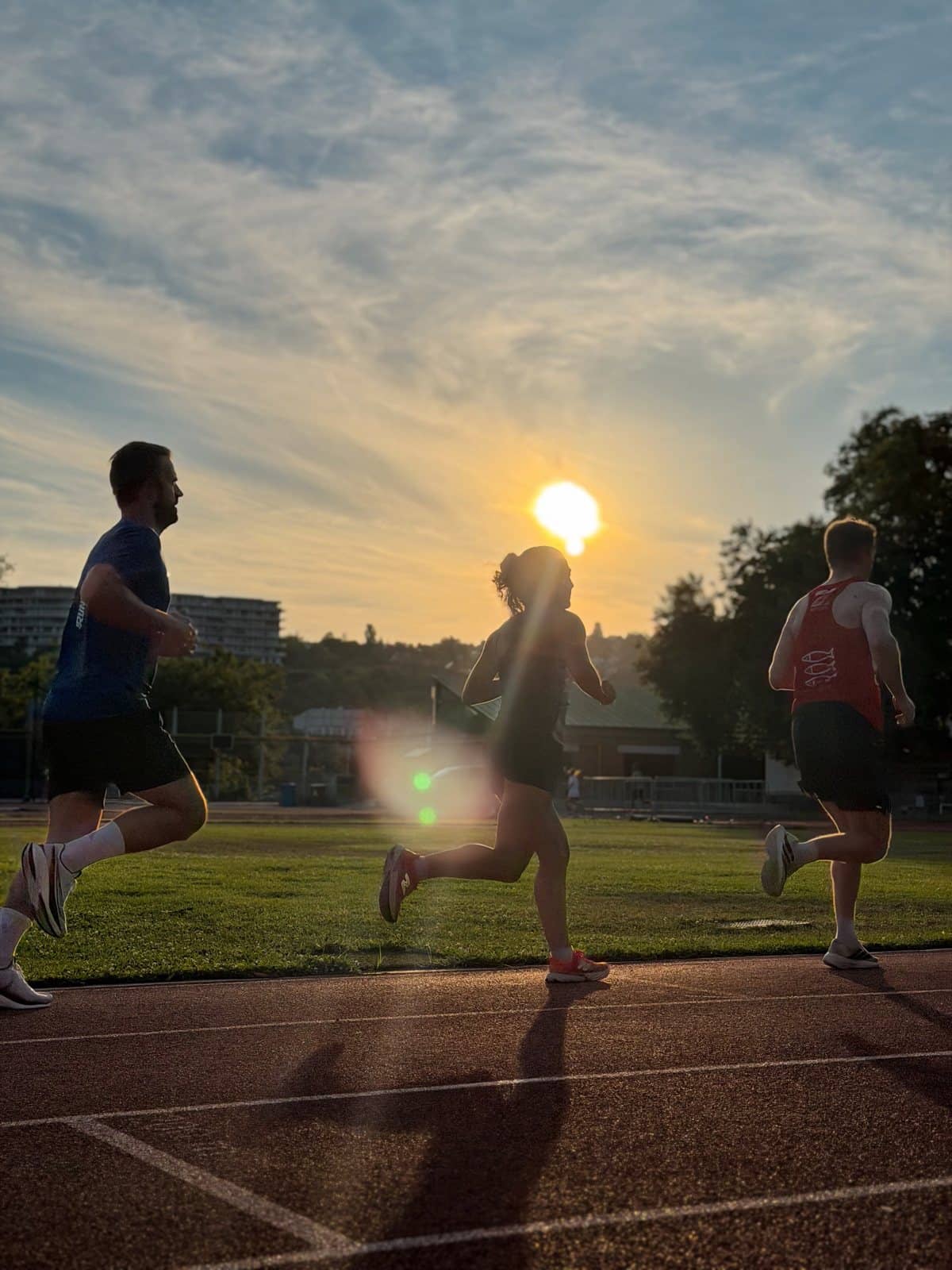 Runners on the Margaret Island track at sunset